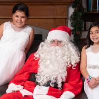 Two little girls with Santa.